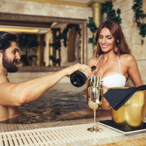 Couple enjoying wine in pool at condo in Aly's Beach, Florida